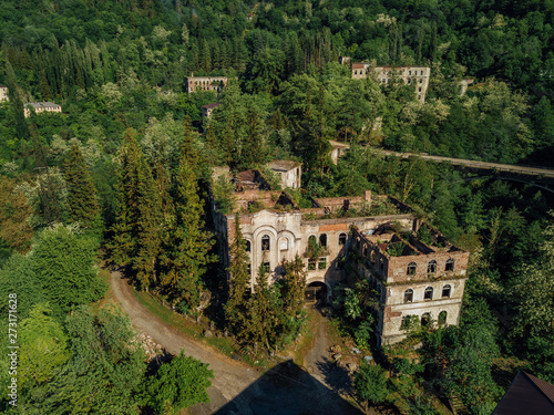 Ruined lost overgrown mining ghost town Akarmara, consequences of war in Abkhazia, aerial view from drone