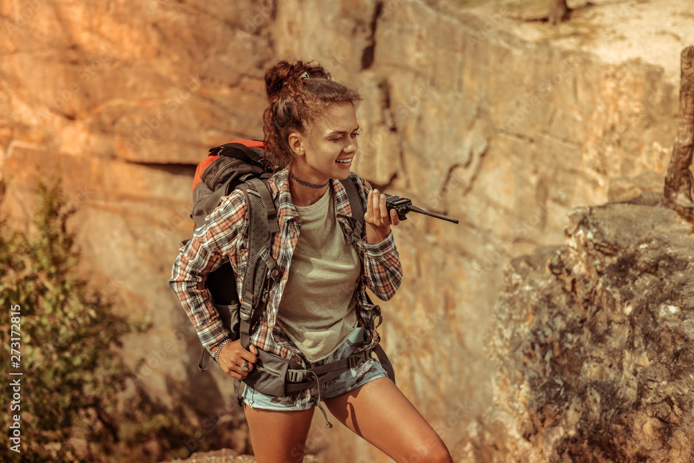 Naklejka premium Pretty attractive woman holding a portable radio set