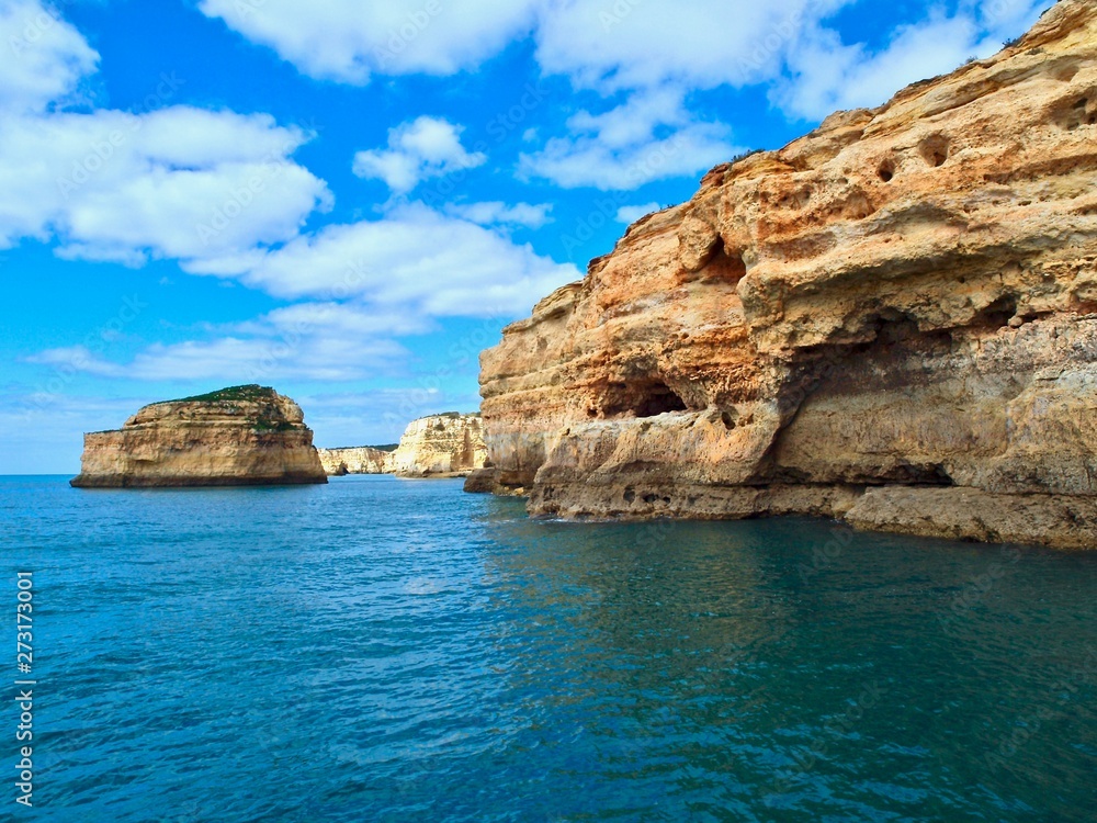 Beautiful cliffs and caves in blue ocean in Albufeira at the Algarve coast of Portugal