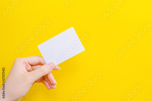 web banner design for business manner and activity concept with beauty woman hand hold name card or credit card in left hand with yellow pastel background
