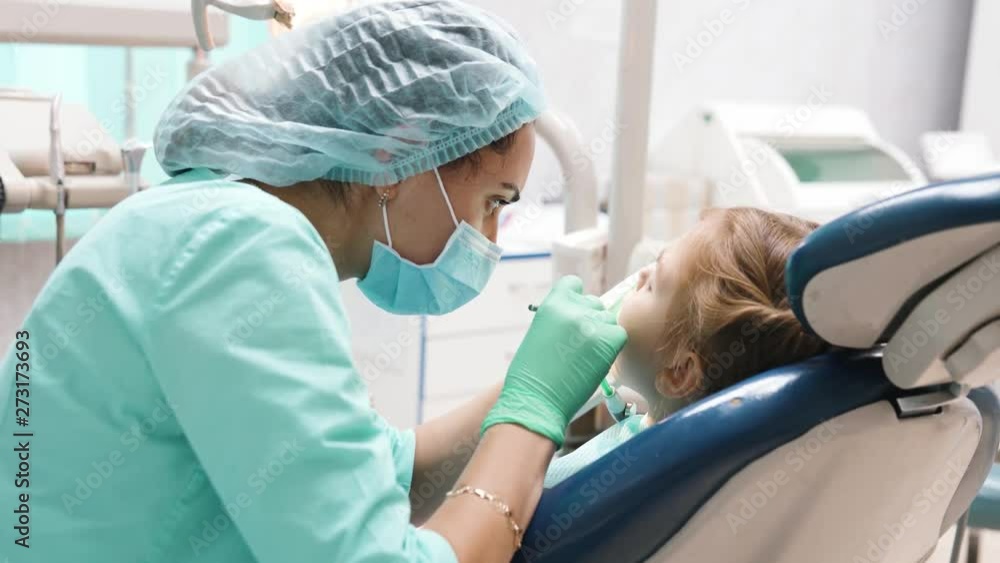 Dentist drills a tooth to the patient to put a seal. The concept of a healthy lifestyle. Dentist drills a tooth to the patient to put a seal. The concept of a healthy lifestyle.