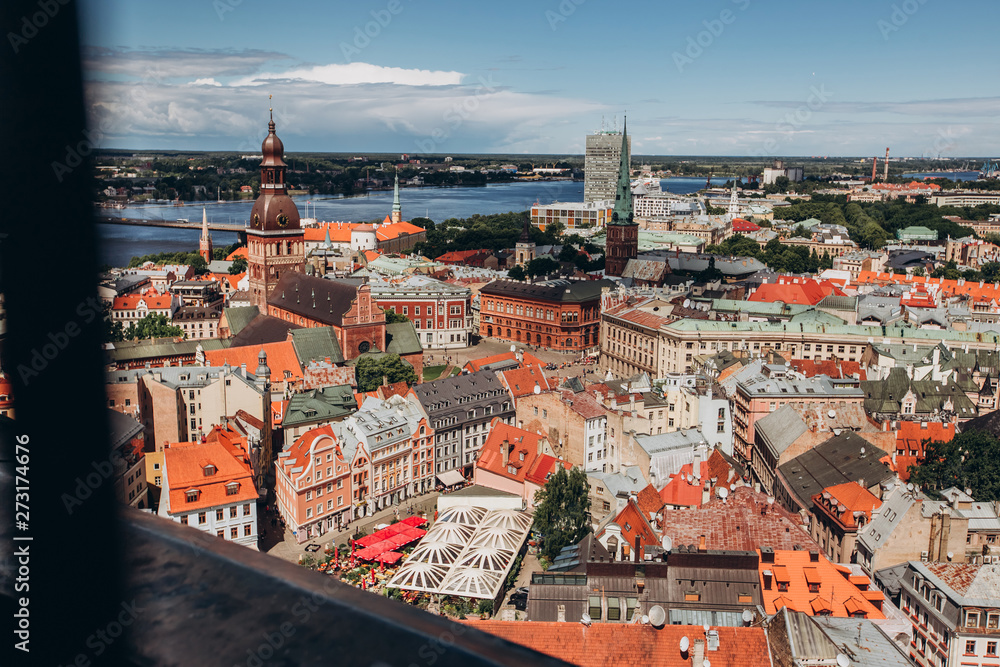 Red roofs of old Riga. Riga cityscape on a sunny summer day. City aerial view of the old town with the Dome Cathedral and the Daugava River in the city of Riga, Latvia