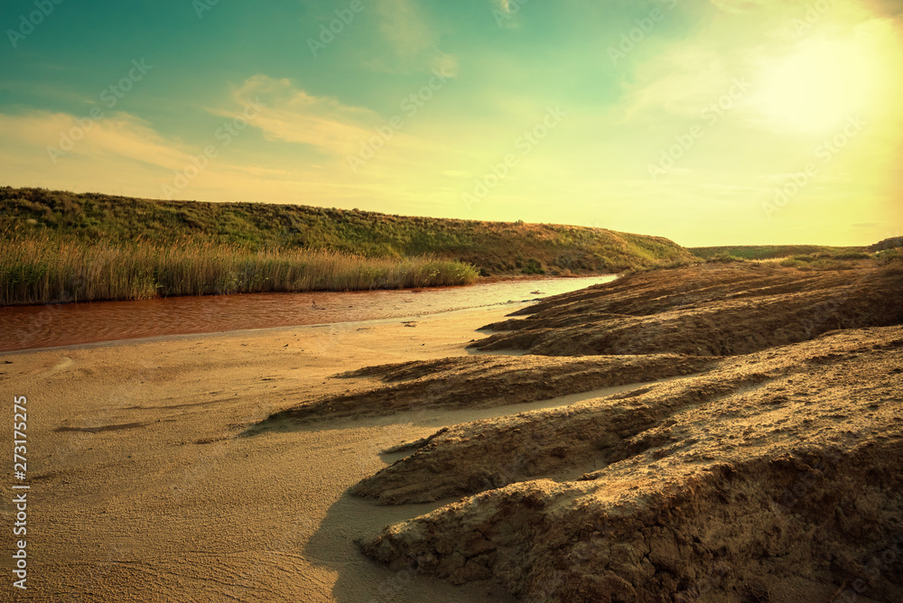 View of small red water river full of iron in beautiful steppe