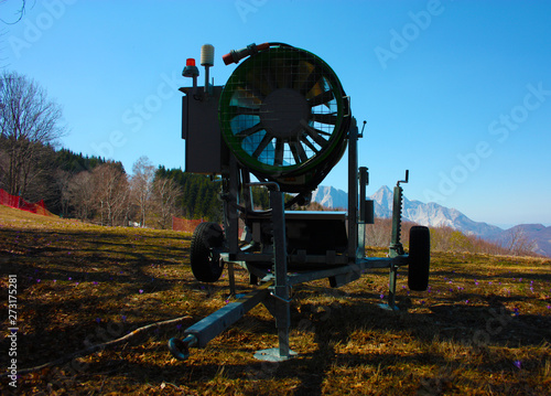 snow cannon for the winter season on the ski and snow slopes. now abandoned tools on the trails, out of season, in spring and summer photo