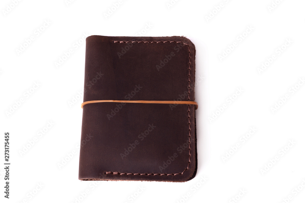 Handmade brown leather cardholder with rubber band isolated on white background closeup. Stock photo of handmade luxury accessories. Handmade brown leather cardholder with rubber band isolated on white background closeup. Stock photo of handmade luxury accessories.