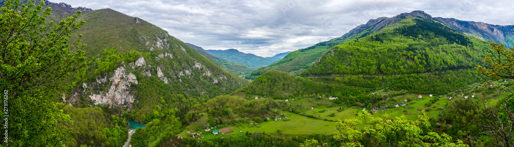 Montenegro, XXL nature landscape panorama from above with view over green forested mountains and canyon with turquoise river