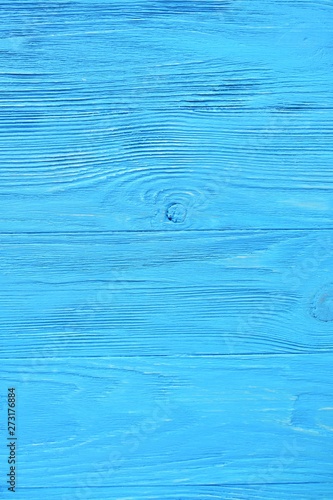 Bright blue textured wood background. Empty wooden backdrop with rough surface. Blank wooden backdrop with grungy natural wood plank. Wooden table with a beautiful structure painted in blue