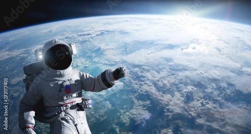 Astronaut conducting spacewalk on Earth orbit.