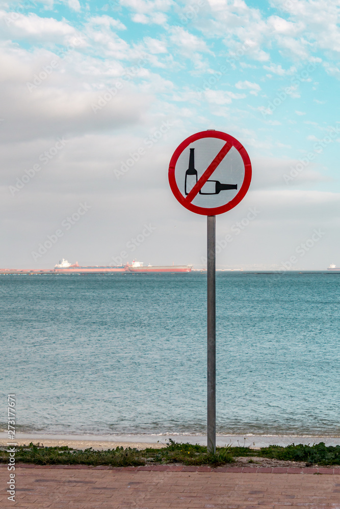 Sign by seaside prohibiting the use of alcohol Sign by seaside prohibiting the use of alcohol