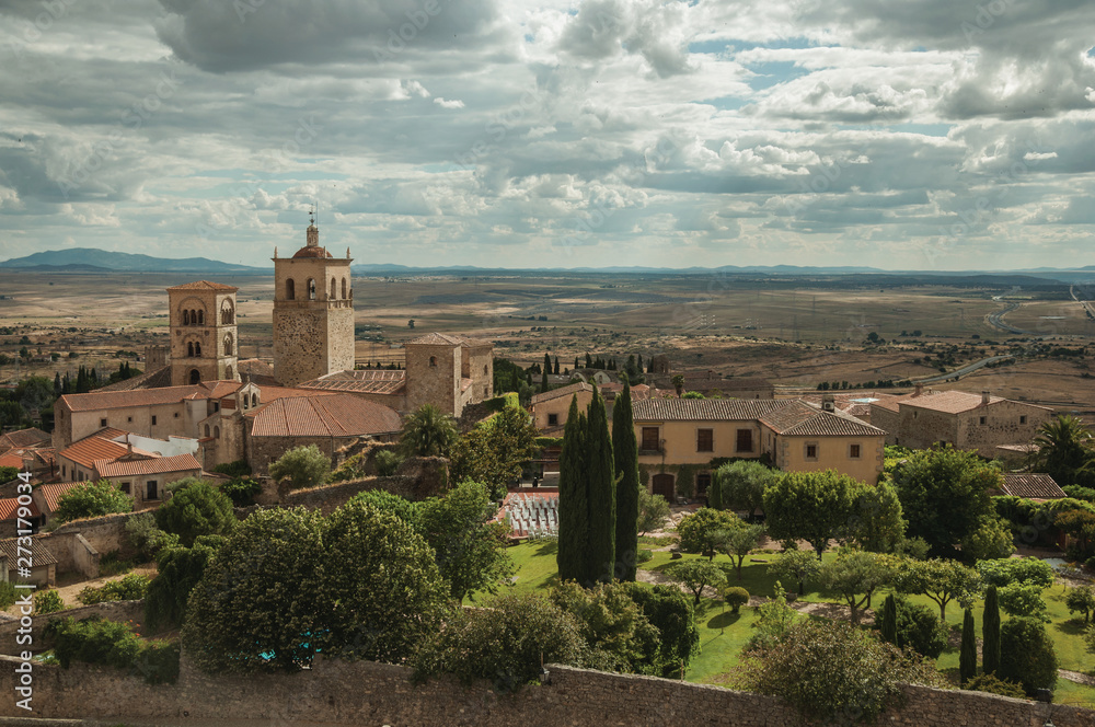Old buildings with church steeples and gardens in a rural landscape seen from the Castle of Trujillo.