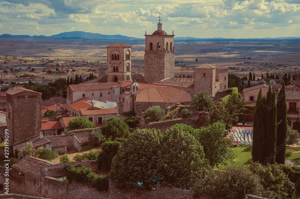 Old buildings with church steeples and gardens in a rural landscape seen from the Castle of Trujillo.