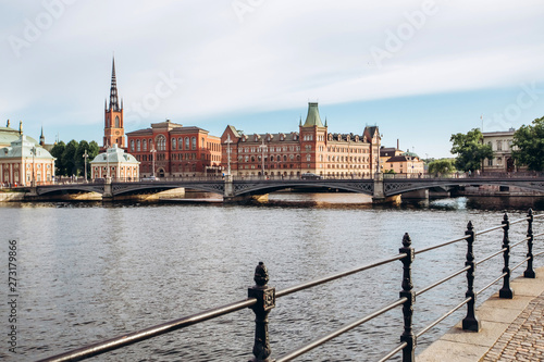 Scenic summer panorama of the Old Town (Gamla Stan) architecture in Stockholm, Sweden. view from Monteliusvagen hill on island Riddarholm and tower of church. Lake Malaren with blue sky, white clouds. photo