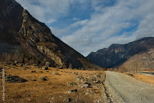 Russia. Mountain Altai. Dirt road in the valley of the river Chulyshman.