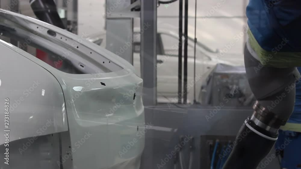 The robot paints the car body at the car factory, Close-up. The robot paints the car body at the car factory, Close-up.