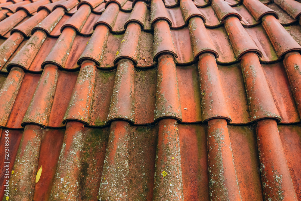 Exterior of brick house with red roof tiles, Prague. Retro red tile roof of old house Exterior of brick house with red roof tiles, Prague. Retro red tile roof of old house