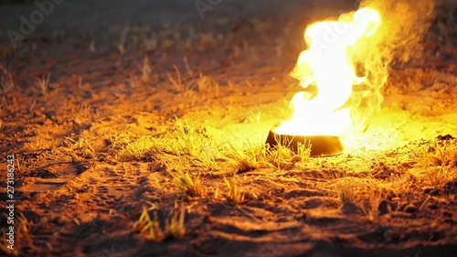 hot fire in a fire bowl on a sandy soil