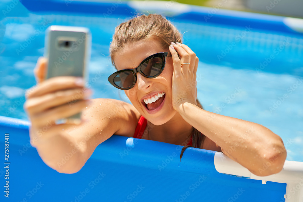 Close up view of attractive woman relaxing on swimming pool in the backyard Close up view of attractive woman relaxing on swimming pool in the backyard