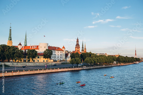 Panoramic view of the Old Town from the cable-stayed bridge to the Daugava embankment at sunset. Riga, Latvia. Riga Castle with the Riga Cathedral in front of. St. Peter's Church in the background.