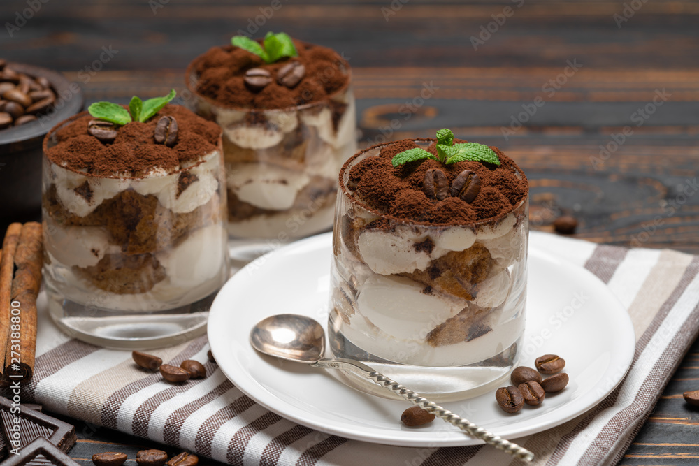 Classic tiramisu dessert in a glass on wooden background Classic tiramisu dessert in a glass on wooden background