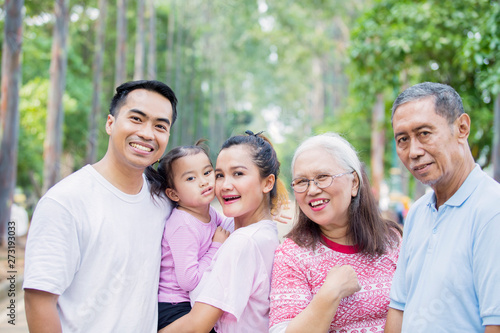 Three generation family smiling at the camera