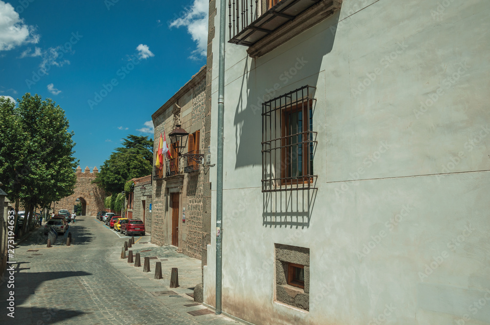 Alley and old building with iron grids on windows at Avila