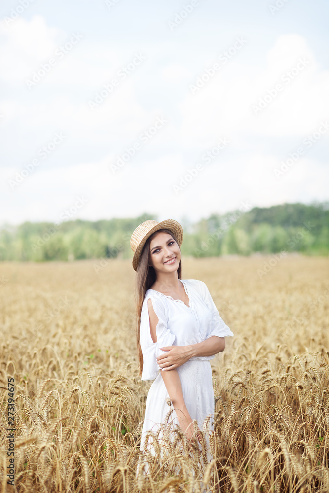 Beauty girl portrait in wheat field at sunset. Attractive young woman smiling and enjoying life. Beautiful brunette with a healthy long haircut. Wellness concept. Rich harvest Concept. Beauty girl portrait in wheat field at sunset. Attractive young woman smiling and enjoying life. Beautiful brunette with a healthy long haircut. Wellness concept. Rich harvest Concept.