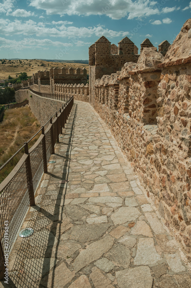 Pathway over old thick wall encircling the town of Avila