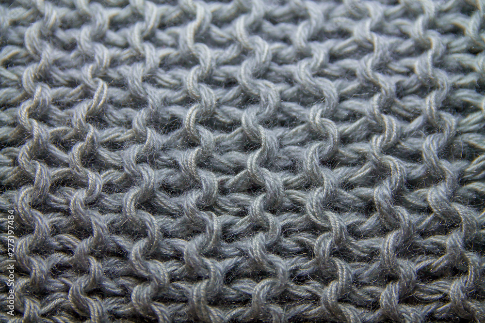 Perspective view of gray handmade knitted pattern background Perspective view of gray handmade knitted pattern background