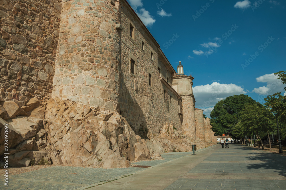 Pedestrian promenade beside large city wall at Avila
