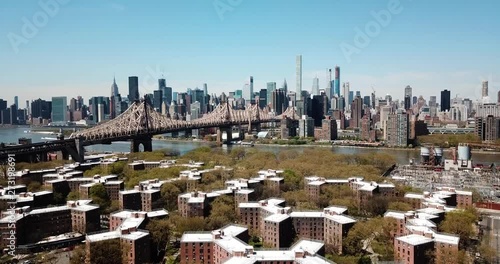 Aerial of Queensborough bridge and downtown manhattan and Queens rooftops