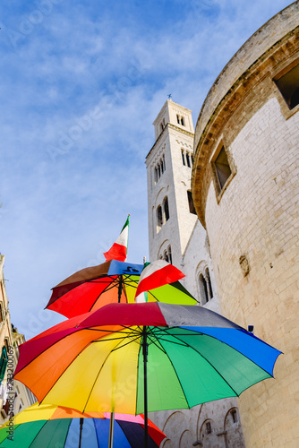 Funny colored umbrella with sky background in a city. © Joaquin Corbalan