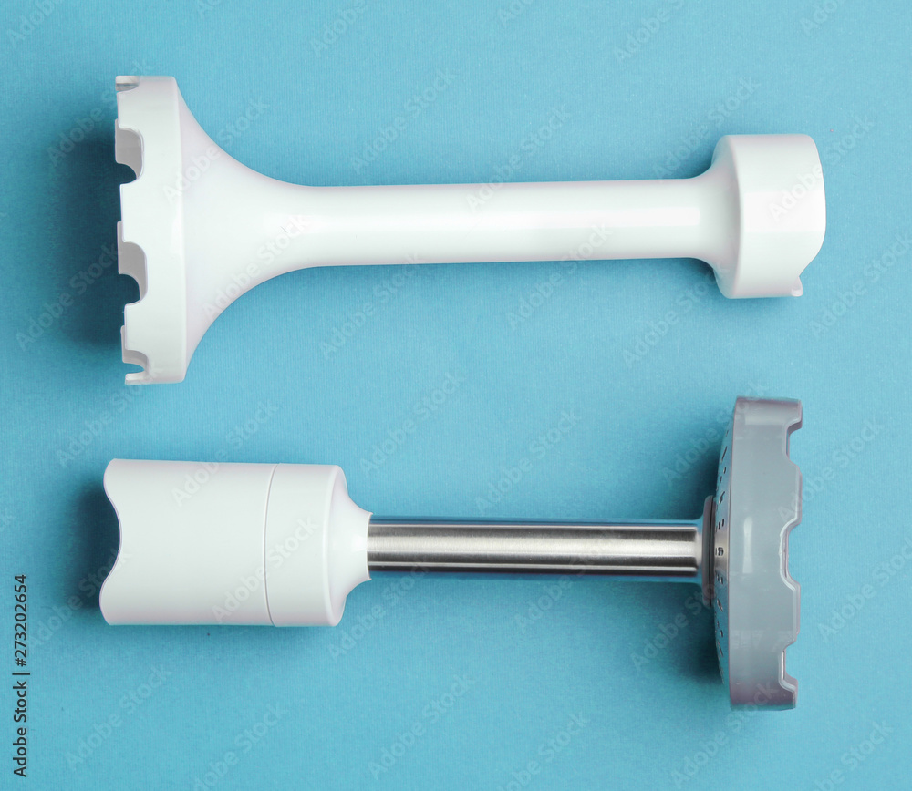 Nozzles for electric hand blender on blue background. Top view Nozzles for electric hand blender on blue background. Top view