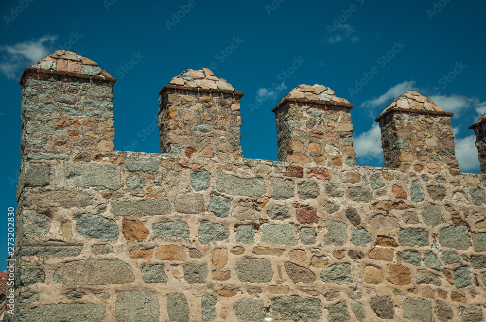 Battlement with merlons and crenels over stone wall at Avila