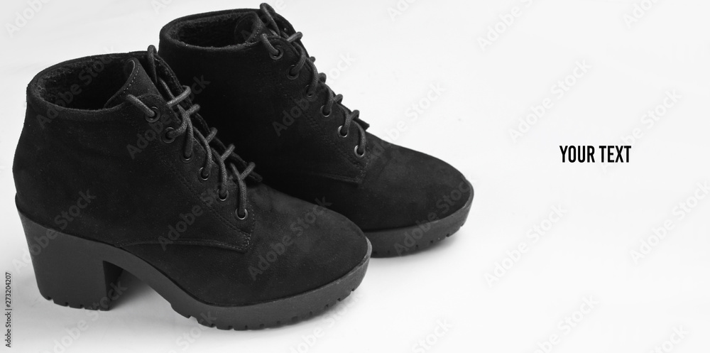 Black suede boots on gray background. Copy space Black suede boots on gray background. Copy space