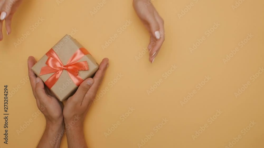 Giving A Box boy gives a box to a girl, congratulating the hands of a young couple ...