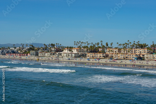 People on the beach enjoying beautiful spring day at Oceanside beach in San Diego, California.  © Unwind