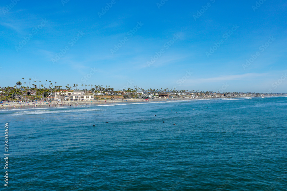 People on the beach enjoying beautiful spring day at Oceanside beach in San Diego, California. 