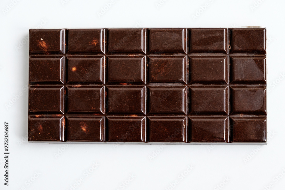 top view of a rectangular tile of classic dark chocolate with divisions into small rectangles for easy eating top view of a rectangular tile of classic dark chocolate with divisions into small rectangles for easy eating