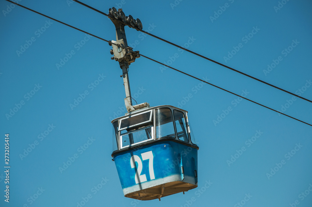 Cable car gondola passing through clear blue sky in Madrid Cable car gondola passing through clear blue sky in Madrid