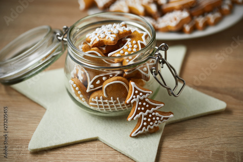 Fotografi Christmas gingerbread in a glass jar on a wooden table.