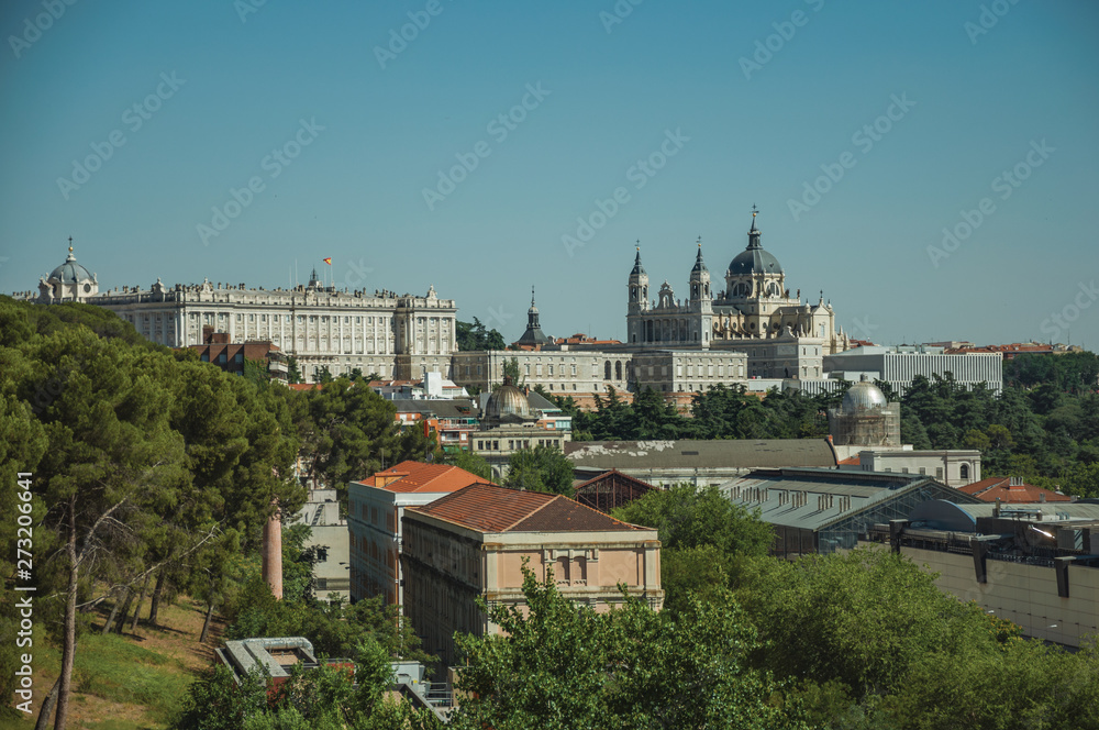 Royal Palace and Almudena Cathedral with buildings among trees in Madrid