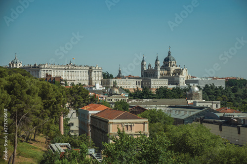 Royal Palace and Almudena Cathedral with buildings among trees in Madrid © Celli07