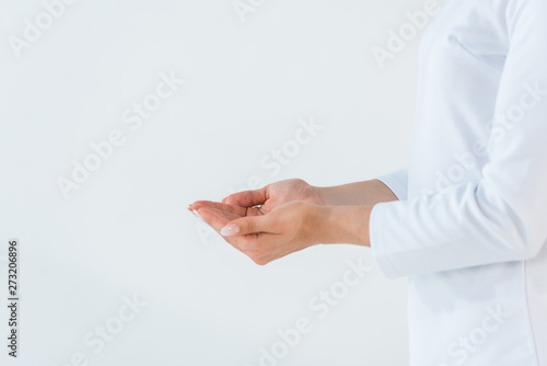 cropped view of woman standing with cupped hands isolated on white