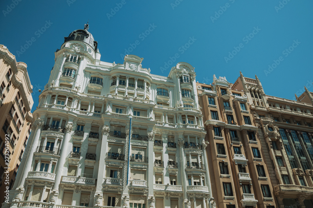 Facade decoration on old buildings full of windows in Madrid