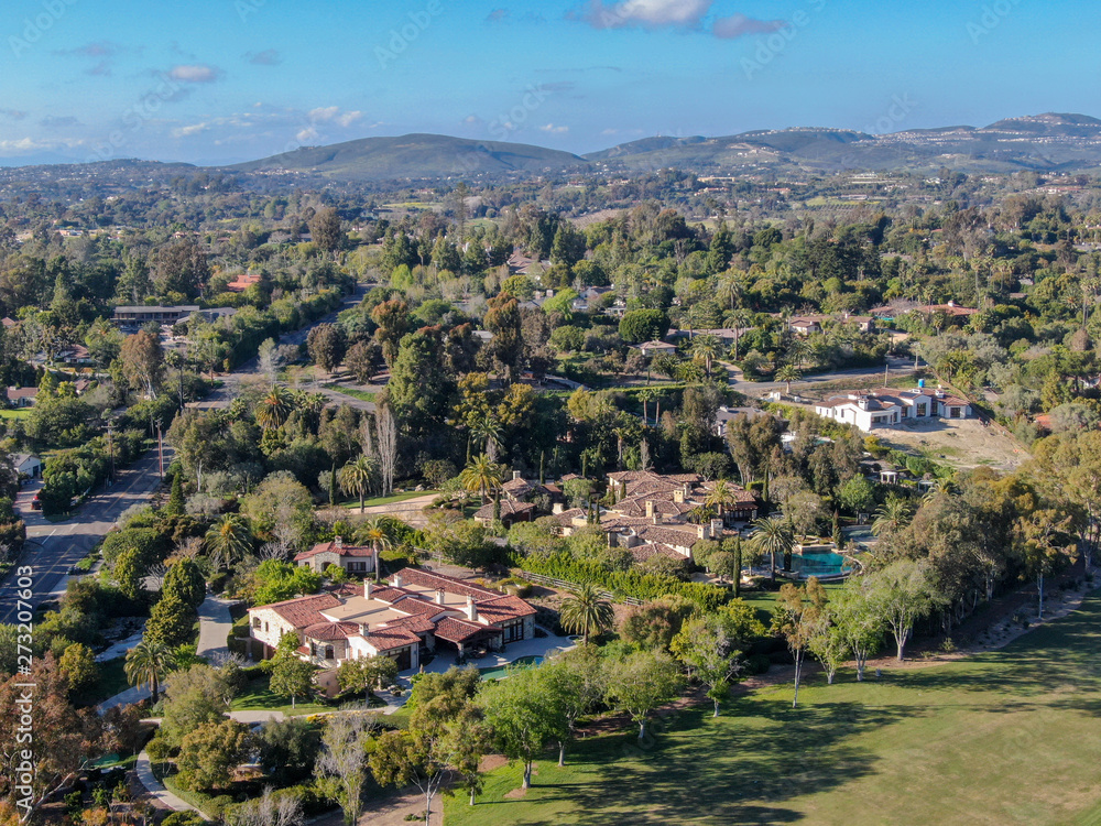 Aerial view of wealthy countryside area with luxury villas with swimming pool, surrounded by forest and mountain valley. Ranch Santa Fe. San Diego, California, USA.