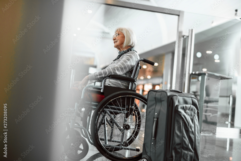 Happy adult lady on disabled carriage waiting for trip Happy adult lady on disabled carriage waiting for trip