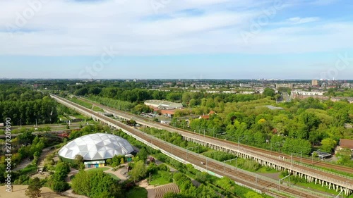 Aerial drone of Rotterdam zoo and park in the Netherlands with an elevated train track going to Central train station. Diergaarde Blijdorp zoo in Holland, Europe photo