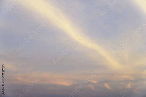 Beautiful sunset sky above rainbow clouds with dramatic light © AnnyPenny