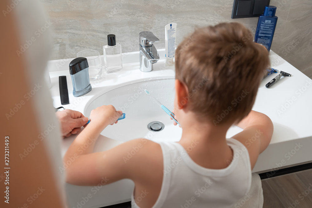 Father and son staying in bathroom at home