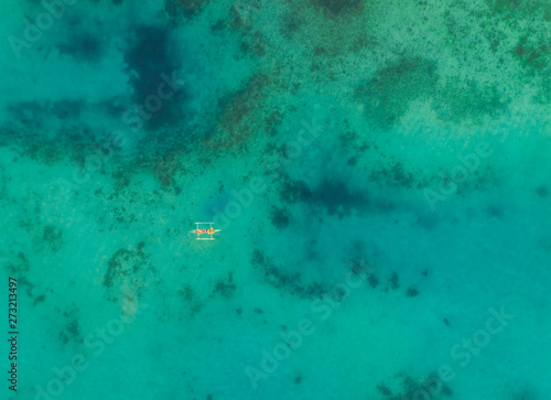 Aerial view of one boat in turquoise waters near Tagbilaran city, Philippines. photo